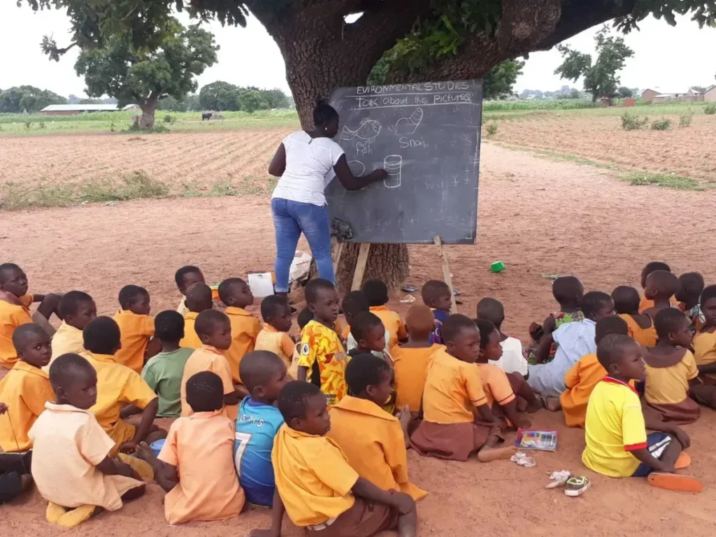 KG class under tree in Ghana