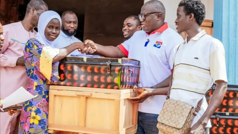 Picture of Ernest Yaw Anim donating trucks and chop boxes