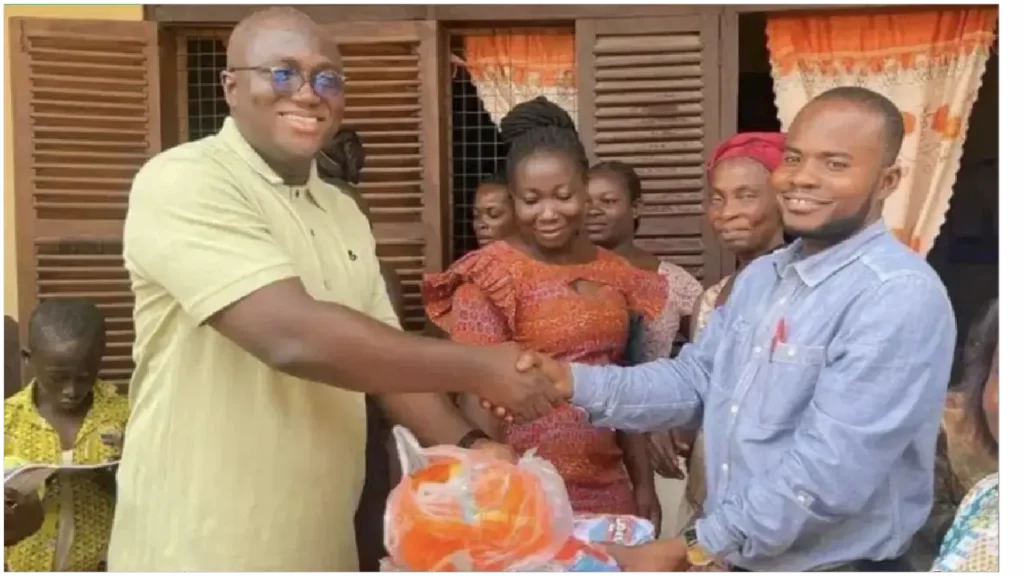 picture of Hon. Ernest Yaw Anim presenting Jersey and Football to one of the Schools