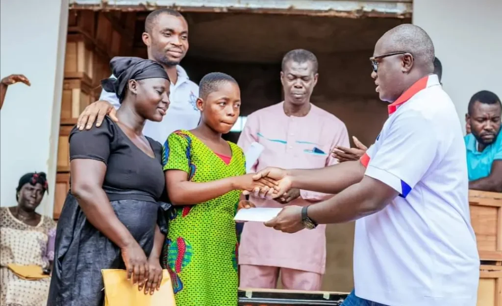 Picture of Kumawu MP donating cash to student