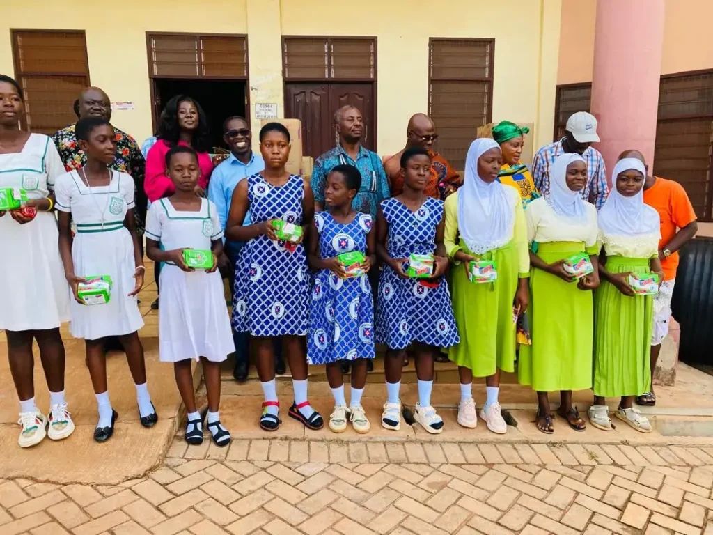 Picture on students receiving pads donation at Kumawu District